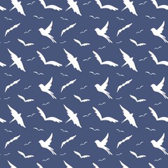 Vector seamless pattern. White doodle birds silhouettes. Isolated on blue background