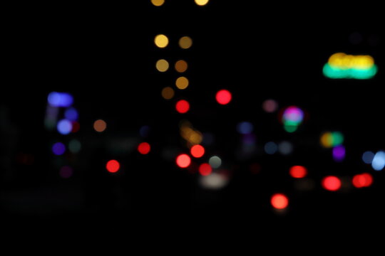 Bokeh of colorful night city lights.City lights big abstract circular bokeh on blue background, The city traffic by night using camera focus as a method