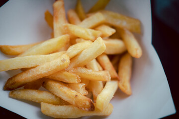 Full of fresh french fries on paper bowl