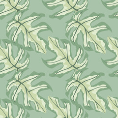 Fototapeta premium Pastel tones seamless doodle pattern with monstera ornament. Tropical leaves silhouettes with light green exotic print.