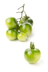 Bundle of unripe green tomatoes over white background