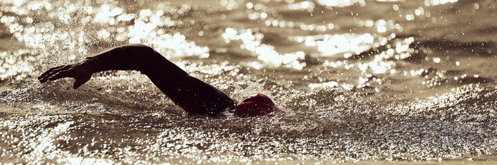 Silhouette man triathlon iron man athlete swimmers swimming	