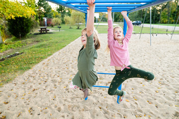 Young girls on monkey bars at playground