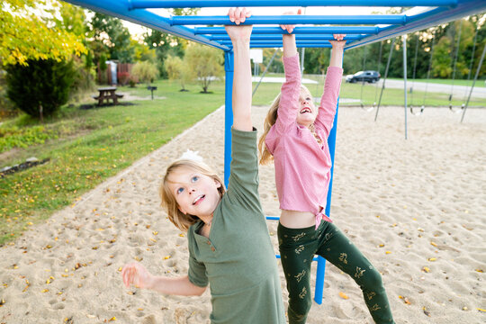 Young girls on monkey bars at playground