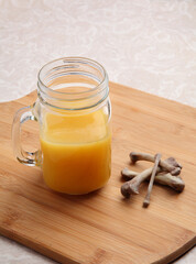 freshly made chicken bone broth in mug with bones nearby