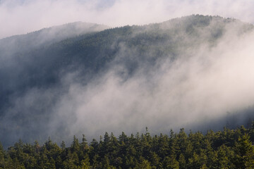 Morning fog over the ridge leading to the top of Mount Monadnock on an autumn morning in Jaffrey New Hampshire