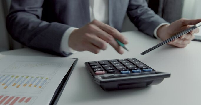 businessman working in office with calculator and digital tablet. business financial reports and data analysis