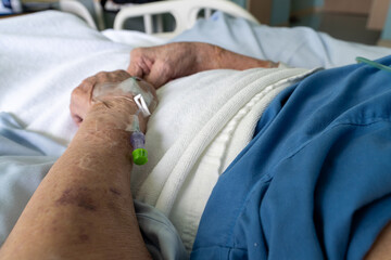 Close up of a Old man patient in hospital with saline intravenous (iv)