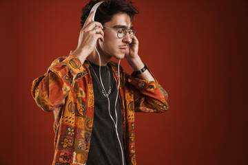 Young man enjoying music isolated