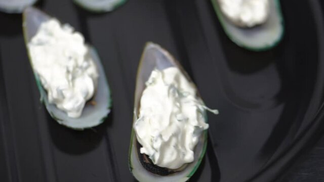 Mussels in a shell with cheese sause on baking sheet. Close-up. HD