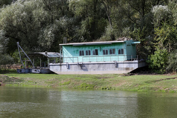 Rusty old ship on the banks of the river.