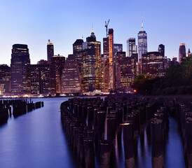 Night photo of glowing skyscrapers and a view of Manhattan Bay. Long duration. Vertical panorama....