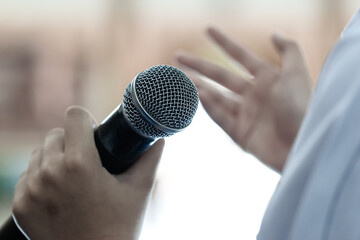 Smart businessman speaker speech with microphone at seminar conference and speaking with mic in...