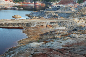 quarries in the place of mining and red refractory clay against the backdrop of red clay mountains and quarries