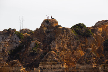 Fototapeta premium Operating a drone in a cliff, Lagos, Algarve, Portugal.
