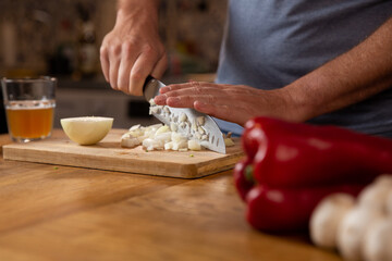 Fototapeta na wymiar Hands chopping and preparing vegetables. 