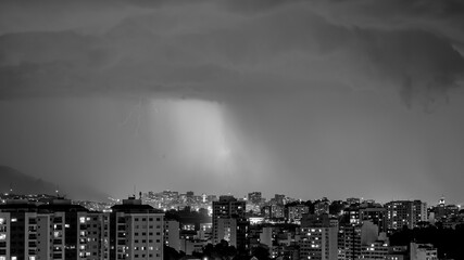 Images of the arrival of a strong summer storm with lightning and rain. Event in the city in the...