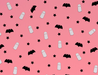 Halloween minimal pattern with ghost and bat, pink background