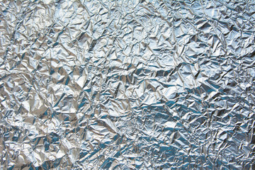 Crumpled plastic coated aluminum foil background texture