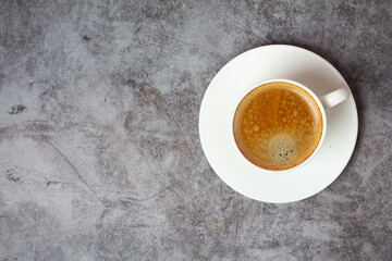 a cup of black coffee on a concrete background and a place for the text.