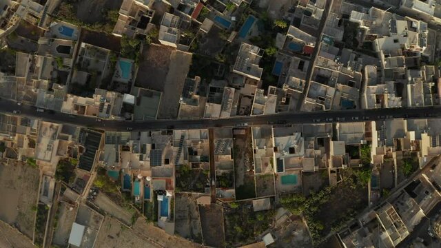 Road in Mediterranean Small Town City with no traffic during Coronavirus Covid 19 Pandemic Lockdown, Brown and Beige Sand Colored Houses, Aerial Birds Eye Overhead Top Down View