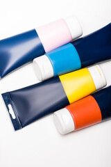 top view of acrylic paint tubes on white background