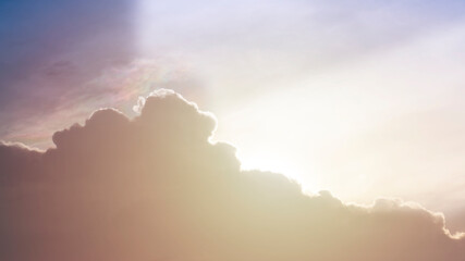 Rays of sun through the clouds dramatic sky at sunset with black, dark and orange colors, thunderstorm background..