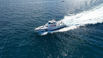 Aerial drone ultra wide photo of Hellenic Coast guard powerboat cruising in high speed near port of...