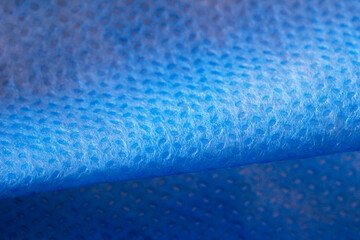 Blue macro surgical mask fabric texture.