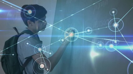 Glowing network of connections against male student writing on blackboard  - Powered by Adobe