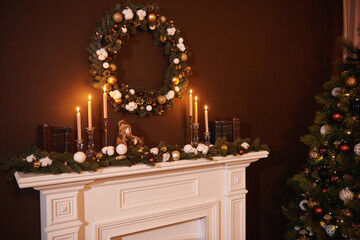 Christmas wreath above classical fireplace