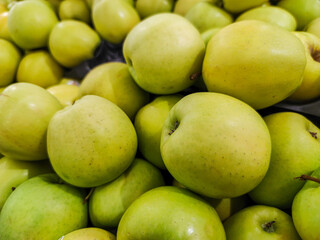 focus on Group of golden apples sold on a market