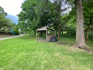 Small park area, with a wooden shelter, old trees, and footpath in the village of, Lothersdale, Keighley, UK