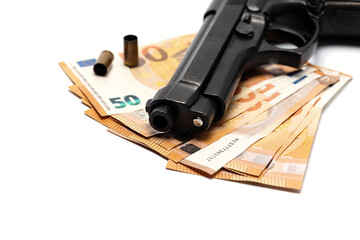  Euro banknotes, gun and empty bullet cartridges close up. Isolated on white. Crime, violence...
