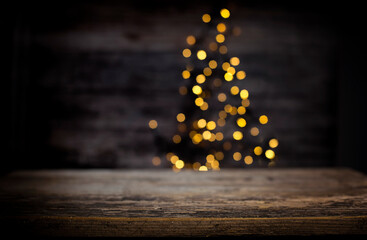 blurred background of xmas tree lights and wall wooden board and free place