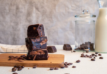 Homemade fudgy chocolate brownies on wooden.