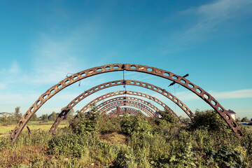 The ruins of an abandoned hangar or greenhouse complex.