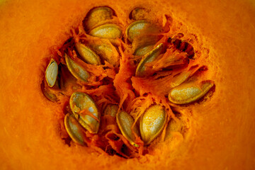 Macro pumpkin texture. Close up of organic, sliced pumpkin with seeds background
