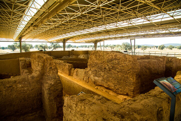 Complex of adobe walls and roof in archaeological site