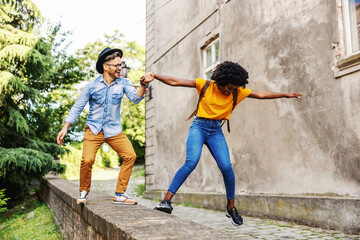 Obraz na płótnie Canvas Young attractive multiracial couple having fun outdoors.