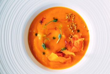 Pumpkin soup on a green background. the view from the top.