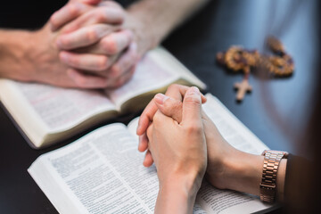 Obraz premium Christians and Bible study concept. Group of discipleship Studying the Word Of God in church ,Christians holding hand and praying together