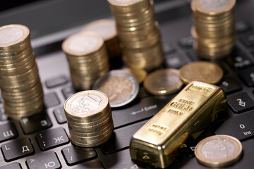 money coins on laptop computer