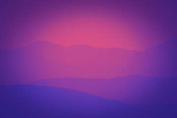 Fototapeta na wymiar Vibrant and colorful purple sunset with silhouette of mountain