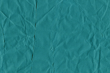 Blue vintage and old looking crumpled paper background. Retro cardboard texture. Grunge paper for drawing. Ancient book page. Present wrapping.