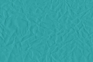 Blue vintage and old looking crumpled paper background. Retro cardboard texture. Grunge paper for drawing. Ancient book page. Present wrapping.