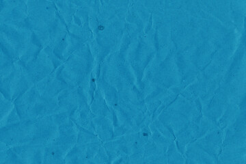 Blue vintage and old looking crumpled paper background. Retro cardboard texture. Grunge paper for drawing. Ancient book page. Present wrapping.