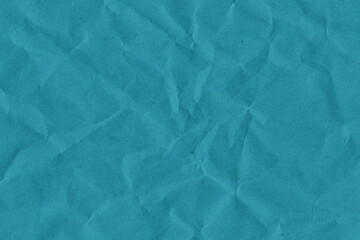 Blue vintage and old looking crumpled paper background. Retro cardboard texture. Grunge paper for drawing. Ancient book page. Present wrapping.