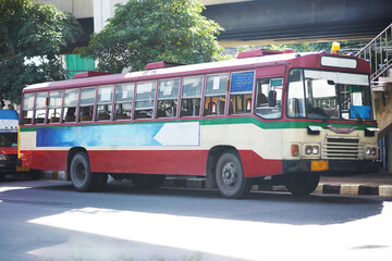 Fototapeta na wymiar Thai public bus for transportation or travel on traffic road scenr
