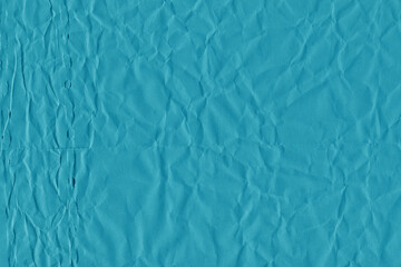 Blue vintage and old looking crumpled paper background. Retro cardboard texture. Grunge paper for drawing. Ancient book page. Present wrapping.